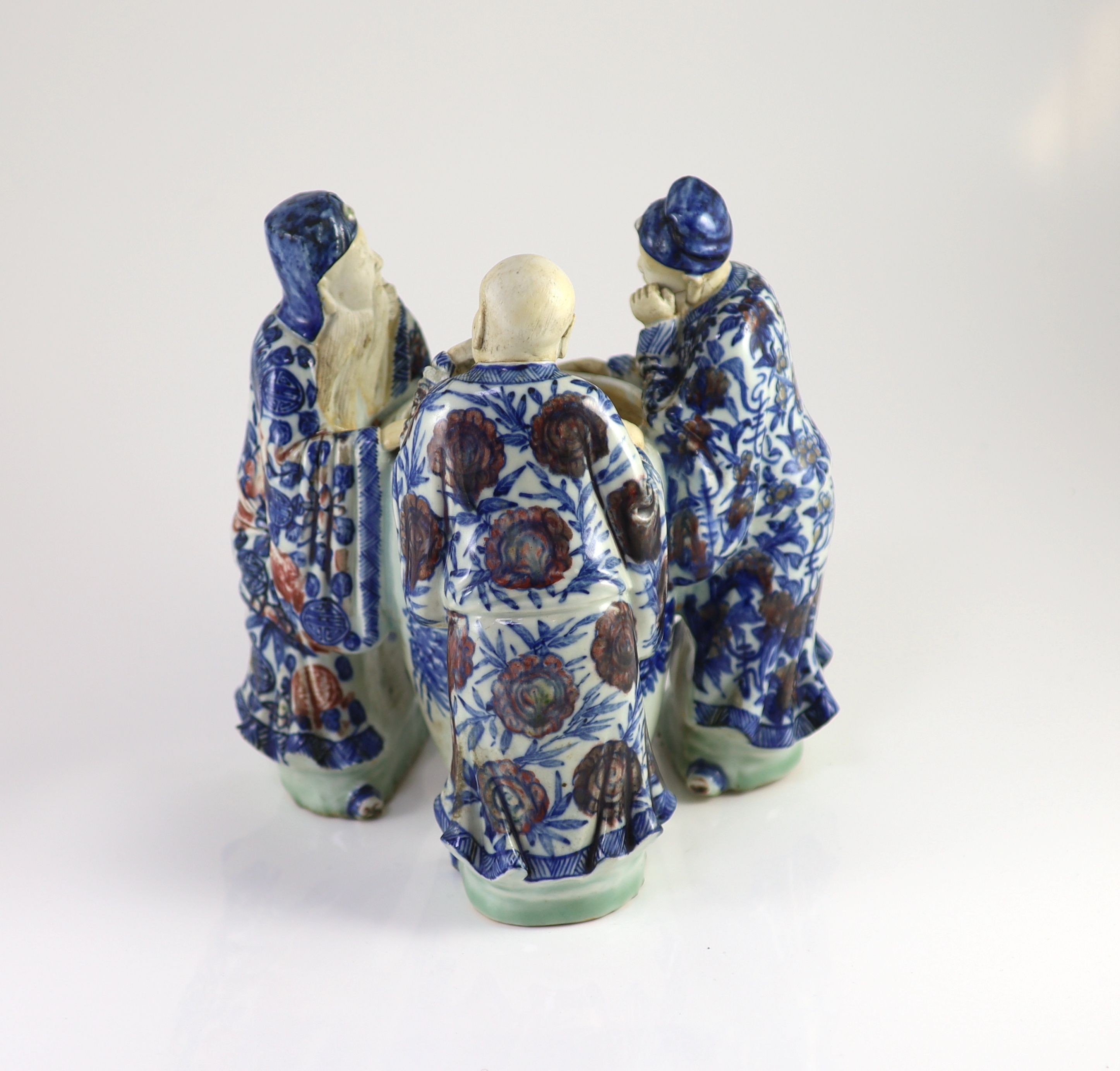 A rare Chinese underglaze blue and copper red porcelain model of the ‘Vinegar Tasters’, Qing dynasty, 26.cm high